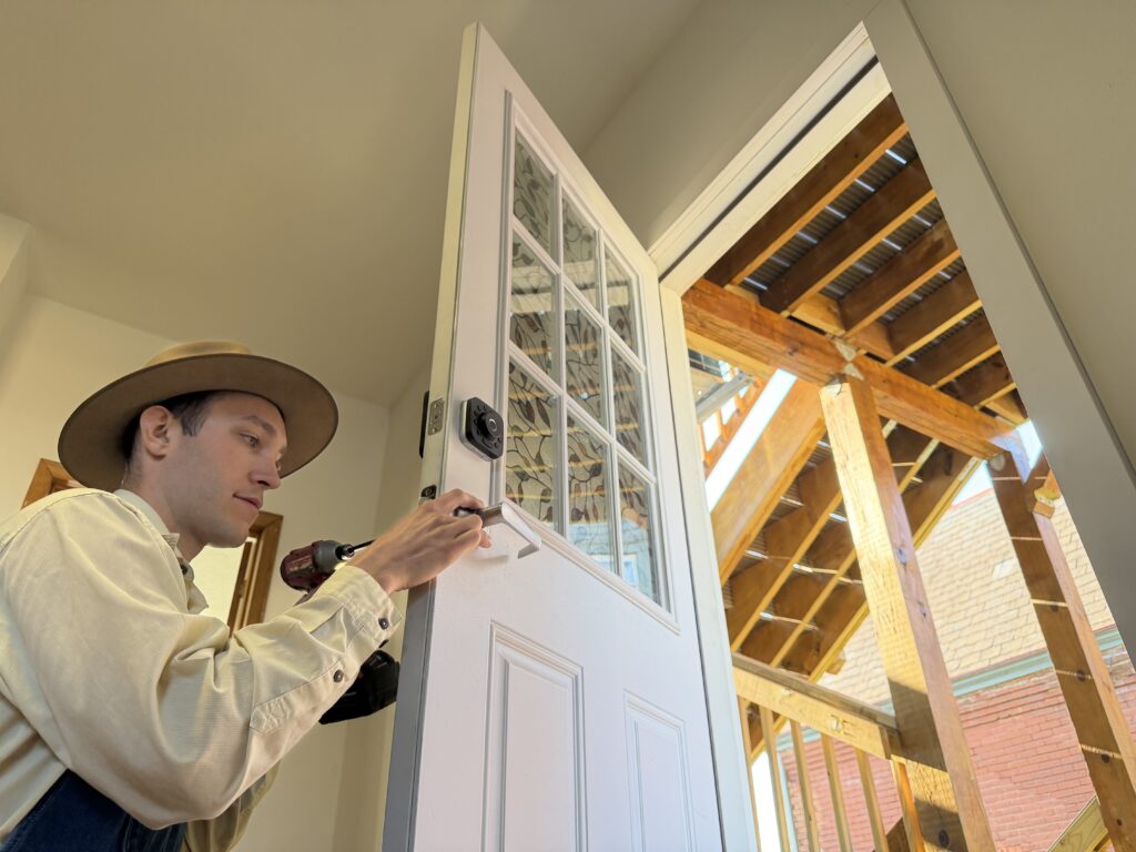 Handyman Patrick fixing a door