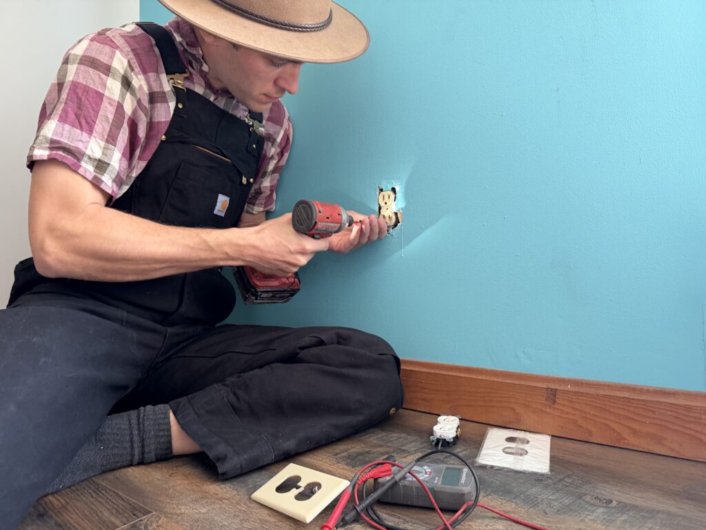 Handyman Patrick repairing an electrical outlet